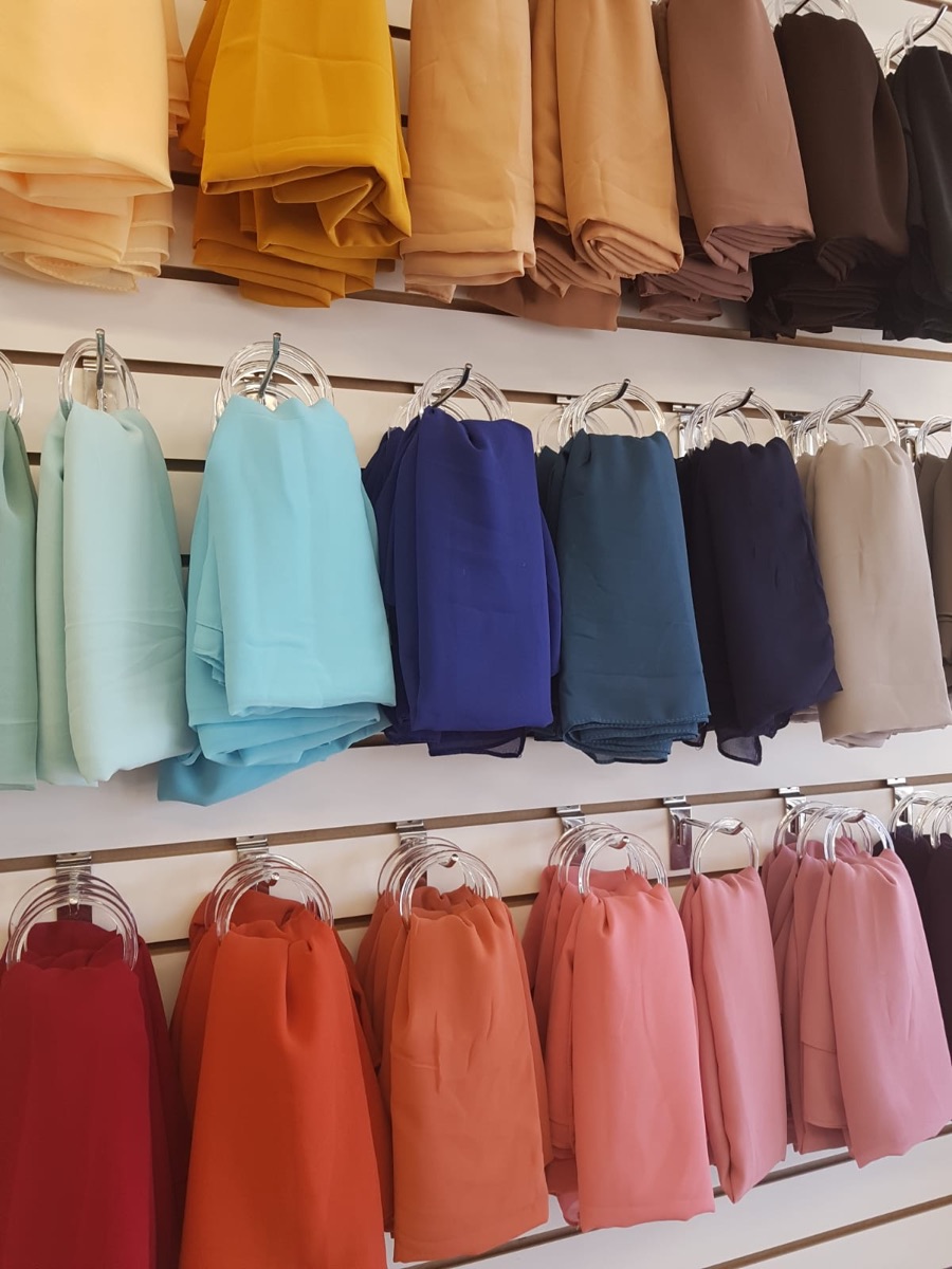 Rows of colourful hijabs displayed in the Nasiye store